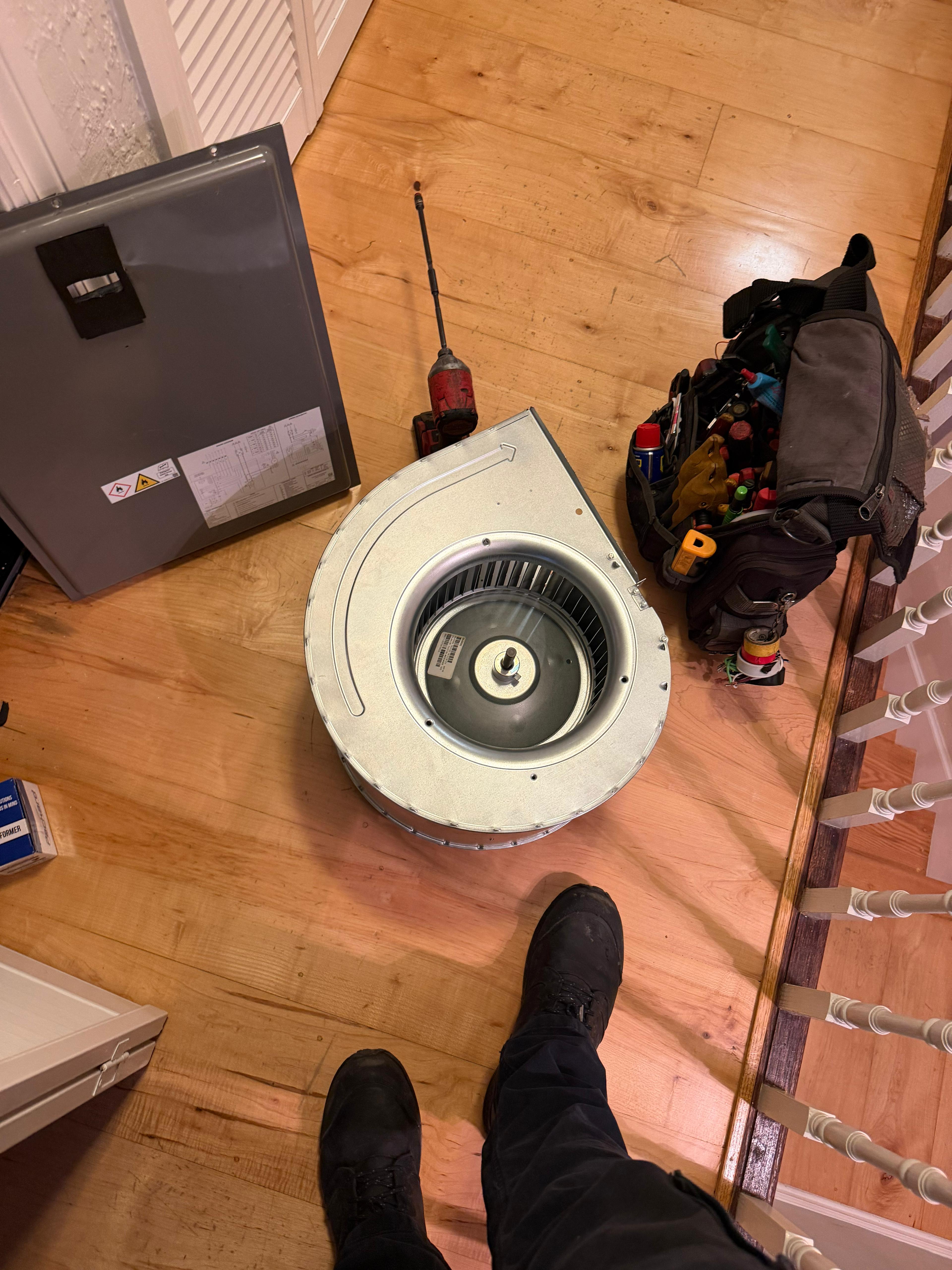 Cooling Masters technician with blower wheel replacement and tool bag