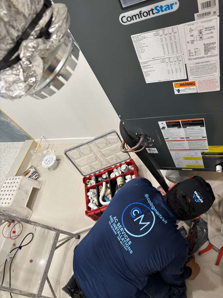 Cooling Masters technician installing a ComfortStar AC unit